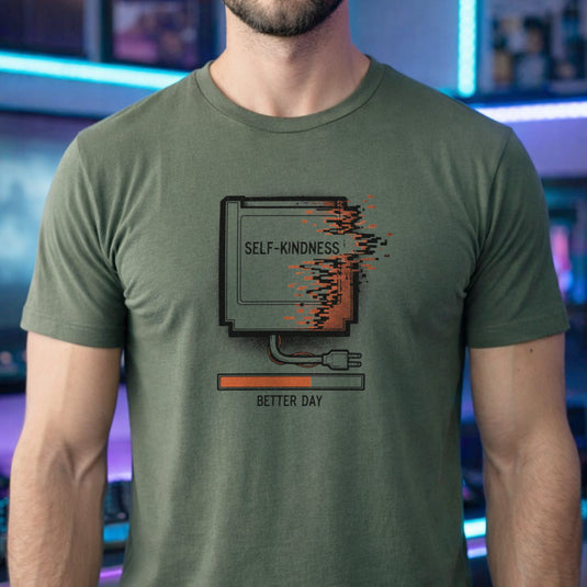 Translation missing: en.Military green tee with a retro gaming cartridge labeled Self-Kindness glitching above a Better Day orange loading bar