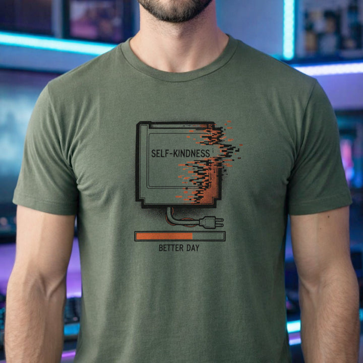 Translation missing: en.Military green tee with a retro gaming cartridge labeled Self-Kindness glitching above a Better Day orange loading bar