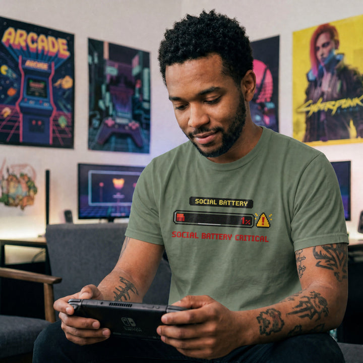 Translation missing: en.Military green shirt with a pixel art one percent loading bar graphic and text reading Social Battery Critical