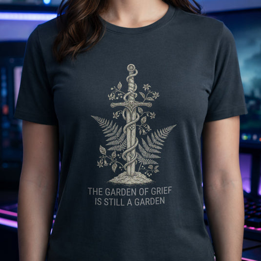Translation missing: en.Dark heather t-shirt graphic with sword wrapped in vines and ferns reading The Garden Of Grief Is Still A Garden