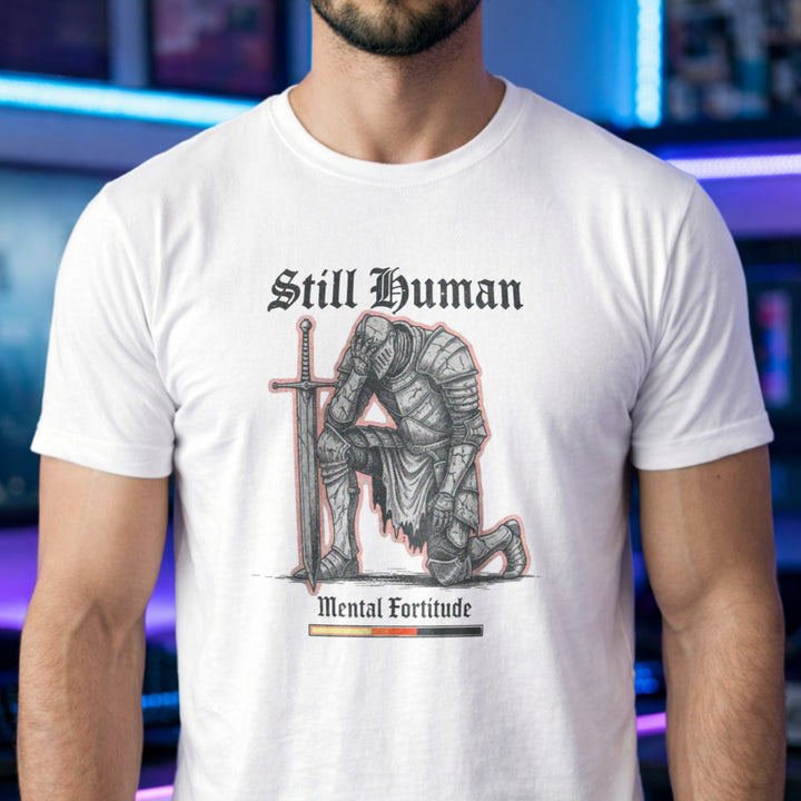 Translation missing: en.White  t-shirt graphic showing a kneeling knight holding his head with text Still Human Mental Fortitude