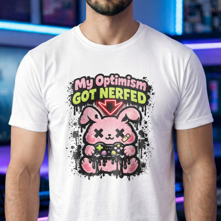 Translation missing: en.White t-shirt with a pink cartoon character and text, My Optimism Got Nerfed in a gaming-themed design
