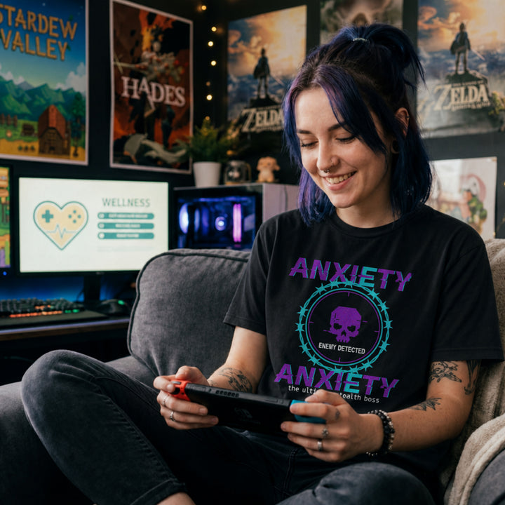 Translation missing: en.Purple and teal pixelated glitch text reading Anxiety Enemy Detected on a black graphic gamer tee