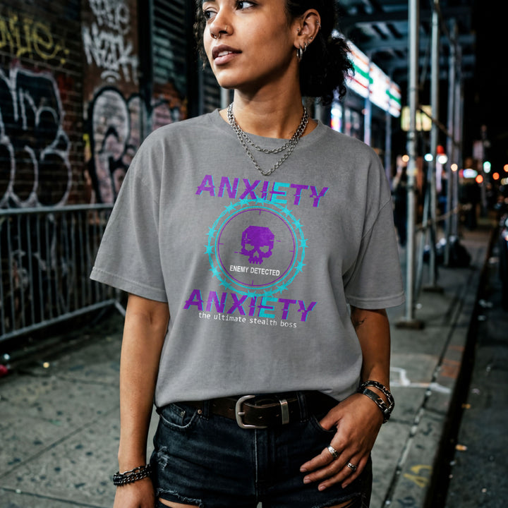 Translation missing: en.Purple and teal pixelated glitch text reading Anxiety Enemy Detected on a graphite heather graphic gamer tee