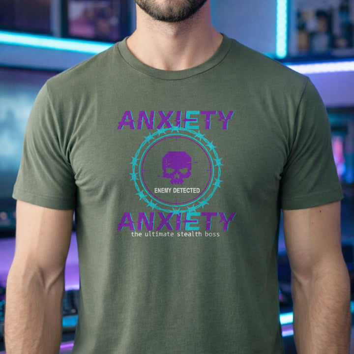 Translation missing: en.Purple and teal pixelated glitch text reading Anxiety Enemy Detected on a military green graphic gamer tee