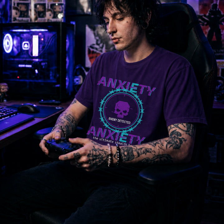 Translation missing: en.Purple and teal pixelated glitch text reading Anxiety Enemy Detected on a purple graphic gamer tee