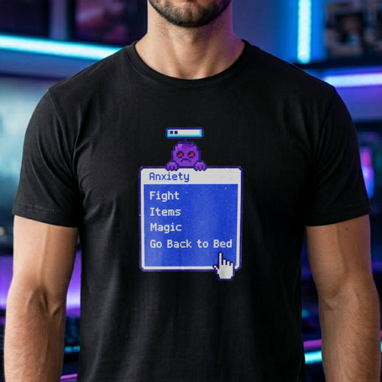 Translation missing: en.Black t-shirt featuring a retro blue RPG battle menu box titled Anxiety with option Go Back to Bed