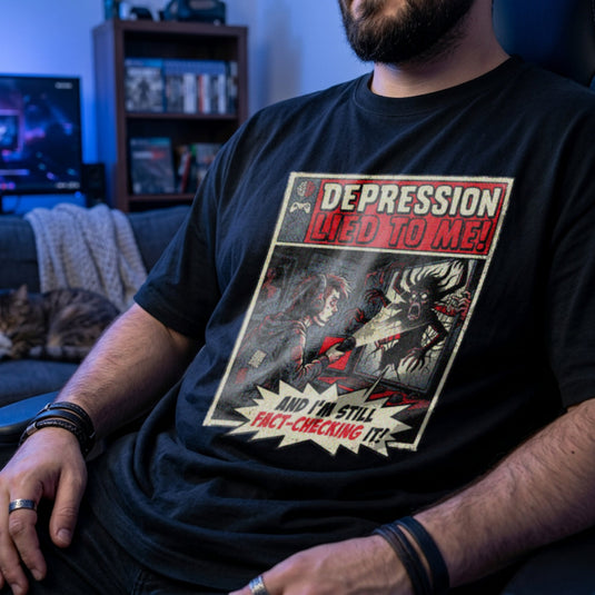 Translation missing: en.Vintage comic art black gamer tee with text 'Depression lied to me, I'm still fact-checking it' shining light at monster