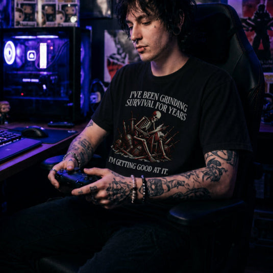 Translation missing: en.Black t-shirt with skeleton warrior sharpening dagger on grindstone graphic and text: Grinding survival for years
