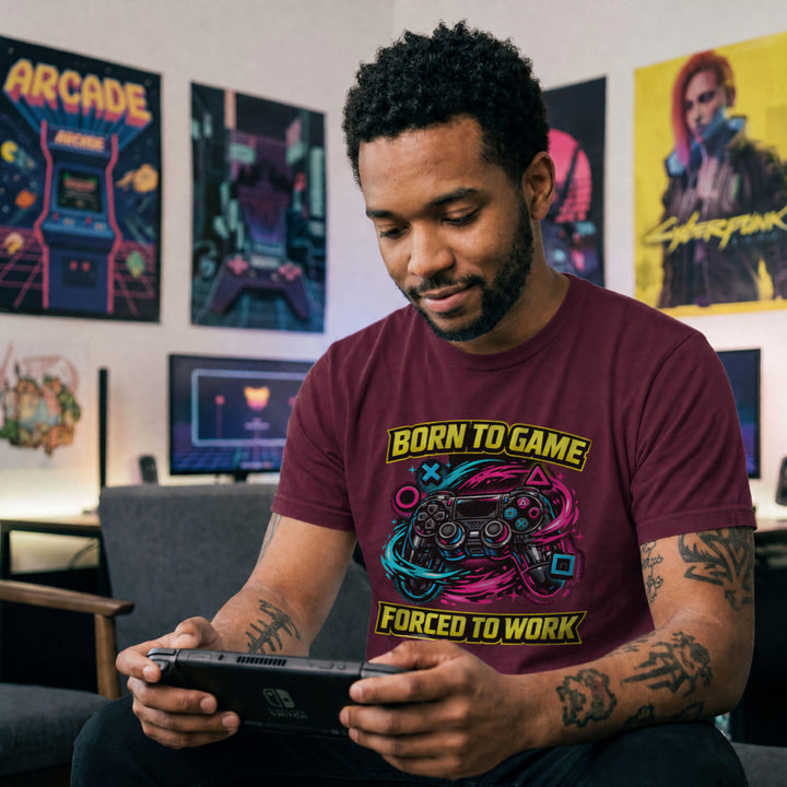 Translation missing: en.Maroon  t-shirt with a neon controller graphic and yellow text Born to Game Forced to Work in banner fonts