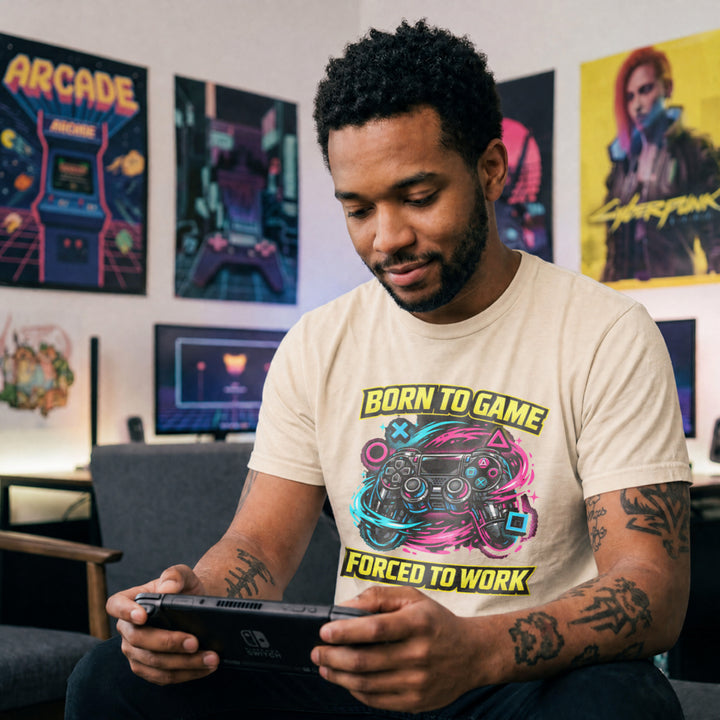 Translation missing: en.Natural t-shirt with a neon controller graphic and yellow text Born to Game Forced to Work in banner fonts