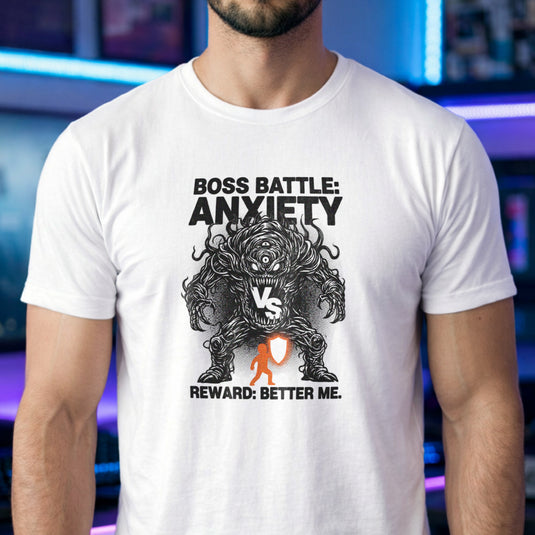 Translation missing: en.White t-shirt with a black line-art monster graphic reading Boss Battle: Anxiety vs a player with a orange shield