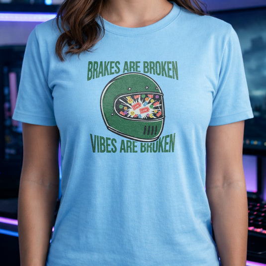 Translation missing: en.Green racing helmet graphic on a light blue t-shirt with text Brakes Are Broken Vibes Are Broken