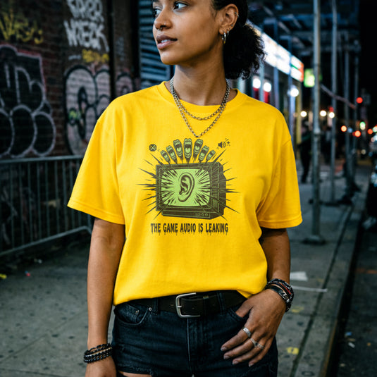 Translation missing: en.Daisy t-shirt with a green retro TV displaying a large ear graphic and text reading THE GAME AUDIO IS LEAKING