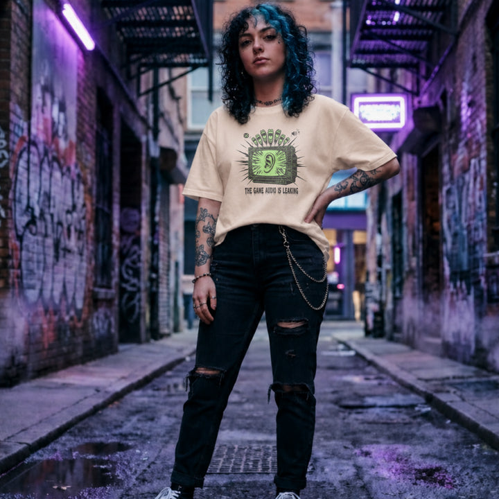 Translation missing: en.Natural t-shirt with a green retro TV displaying a large ear graphic and text reading THE GAME AUDIO IS LEAKING