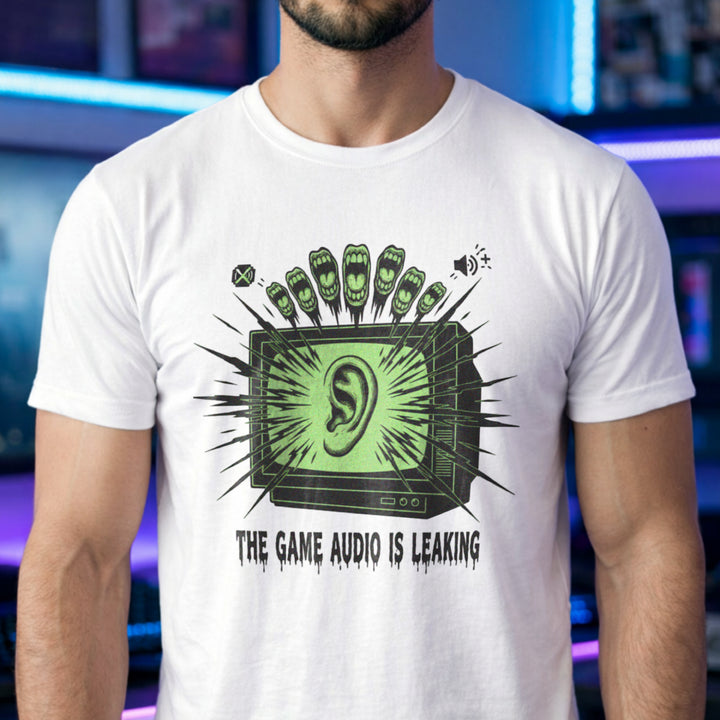 Translation missing: en.White t-shirt with a green retro TV displaying a large ear graphic and text reading THE GAME AUDIO IS LEAKING