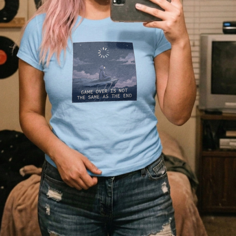 Translation missing: en.Alt n Vibe light blue women's cotton tee with hooded figure under starry sky and Game Over Is Not The Same As The End text