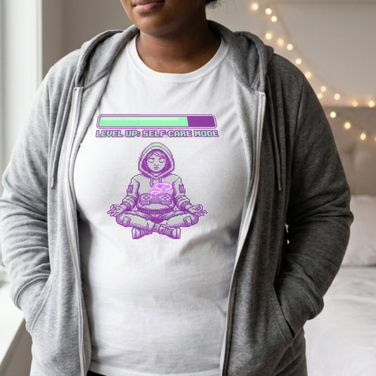 Translation missing: en.Alt n Vibe white women's t-shirt with a pixel art girl meditating in a hoodie under a Level Up Self Care Mode loading bar