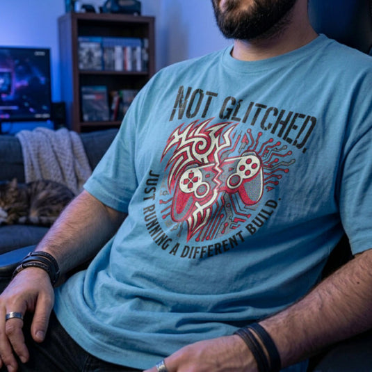 Translation missing: en.Light blue t-shirt with a brain circuit board, gaming controller graphic, and Running a Different Build text