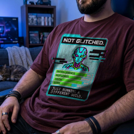 Translation missing: en.Maroon men's heavy cotton t-shirt with pixel art cyborg stat card reading Not Glitched