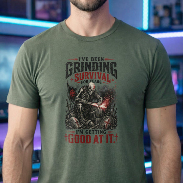 Translation missing: en.Military green t-shirt with skeleton warrior sharpening sword on grindstone graphic and text: Grinding survival for years