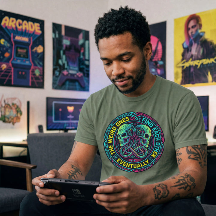 Translation missing: en.Military green t-shirt with neon cyber skulls emblem and text: The weird ones find each other eventually gaming graphic