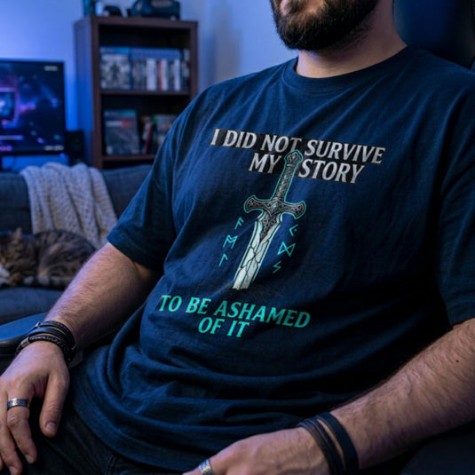 Translation missing: en.Navy t-shirt with a fantasy sword in the ground, glowing runes, and a motivational story survivor quote