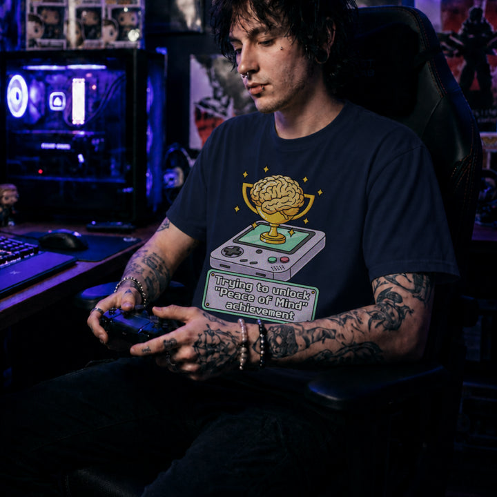 Translation missing: en.Navy t-shirt featuring a retro handheld console with a brain trophy and Peace of Mind achievement text box