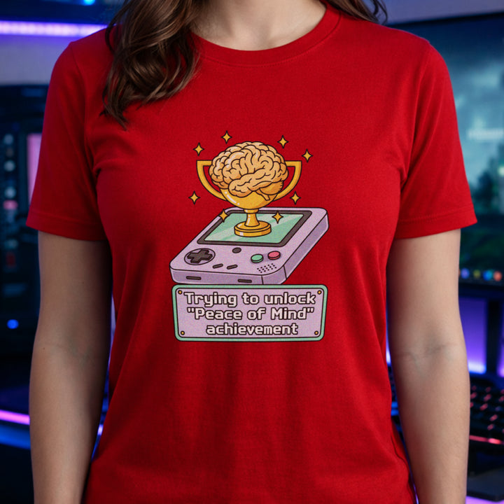Translation missing: en.Red t-shirt featuring a retro handheld console with a brain trophy and Peace of Mind achievement text box