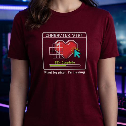 Translation missing: en.Cardinal red t-shirt with pixel art heart stat box reading 65% Complete and text Pixel by pixel, I'm healing