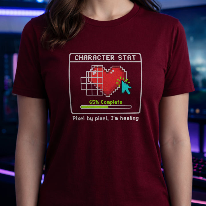 Translation missing: en.Cardinal red t-shirt with pixel art heart stat box reading 65% Complete and text Pixel by pixel, I'm healing