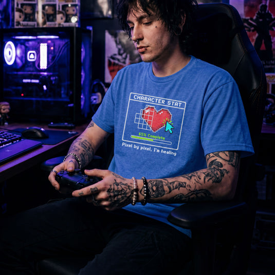 Translation missing: en.Heather royal t-shirt with pixel art heart stat box reading 65% Complete and text Pixel by pixel, I'm healing
