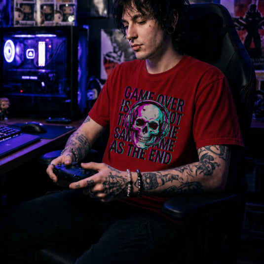 Translation missing: en.Red t-shirt with a neon glitch skull wearing a headset and text Game Over Is Not The Same As The End