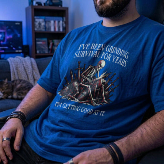 Translation missing: en.Royal t-shirt with skeleton warrior sharpening dagger on grindstone graphic and text: Grinding survival for years