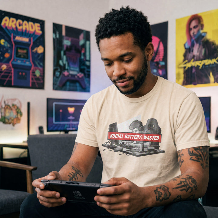 Translation missing: en.Natural t-shirt with tired gamer slumping at desk with headphones  and red banner reading Social Battery: Wasted