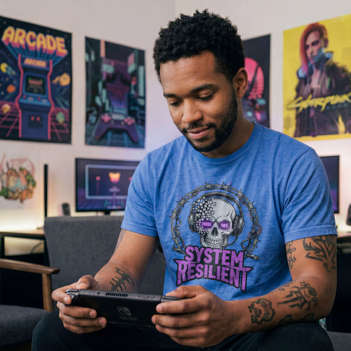 Translation missing: en.Heather navy tee graphic showing a pixelating skull wearing gaming headphones inside barbed wire reading SYSTEM RESILIENT