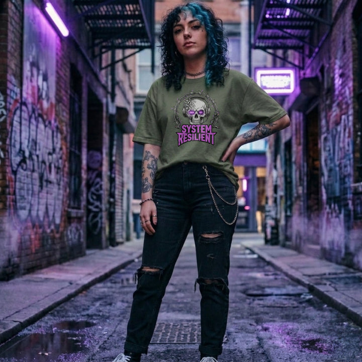 Translation missing: en.Military green tee graphic showing a pixelating skull wearing gaming headphones inside barbed wire reading SYSTEM RESILIENT