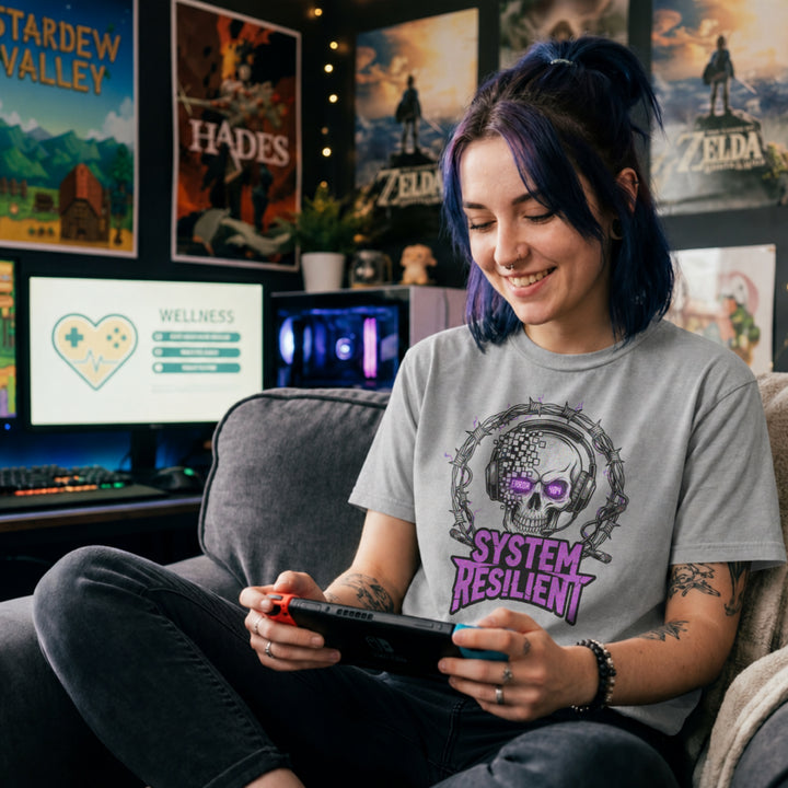 Translation missing: en.Sports grey tee graphic showing a pixelating skull wearing gaming headphones inside barbed wire reading SYSTEM RESILIENT