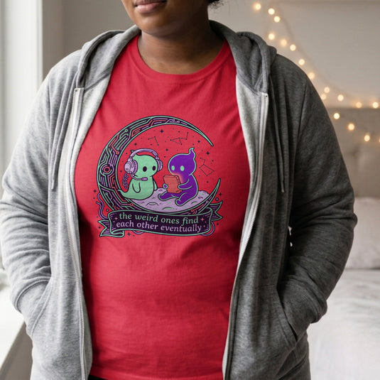 Translation missing: en.Alt n Vibe red women's t-shirt with two cute alien characters playing games under stars reading The Weird Ones Find Each Other