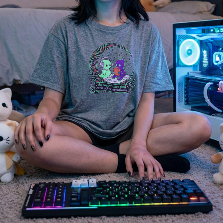 Translation missing: en.Alt n Vibe sports grey women's t-shirt with two cute alien characters playing games under stars reading The Weird Ones Find Each Other